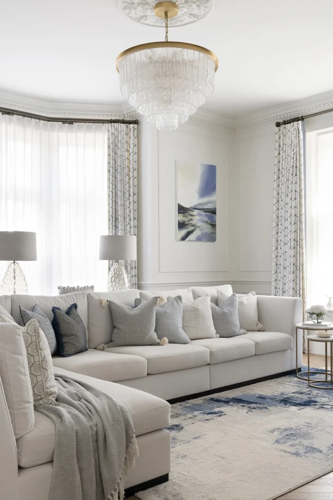 Restored Victorian living room in South Wales featuring original ornate cornicing, a period fireplace, and contemporary furnishings by Wells and Maguire.